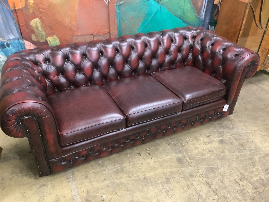 A Victorian style buttoned burgundy leather three seater Chesterfield settee, width 200cm depth 84cm height 72cm